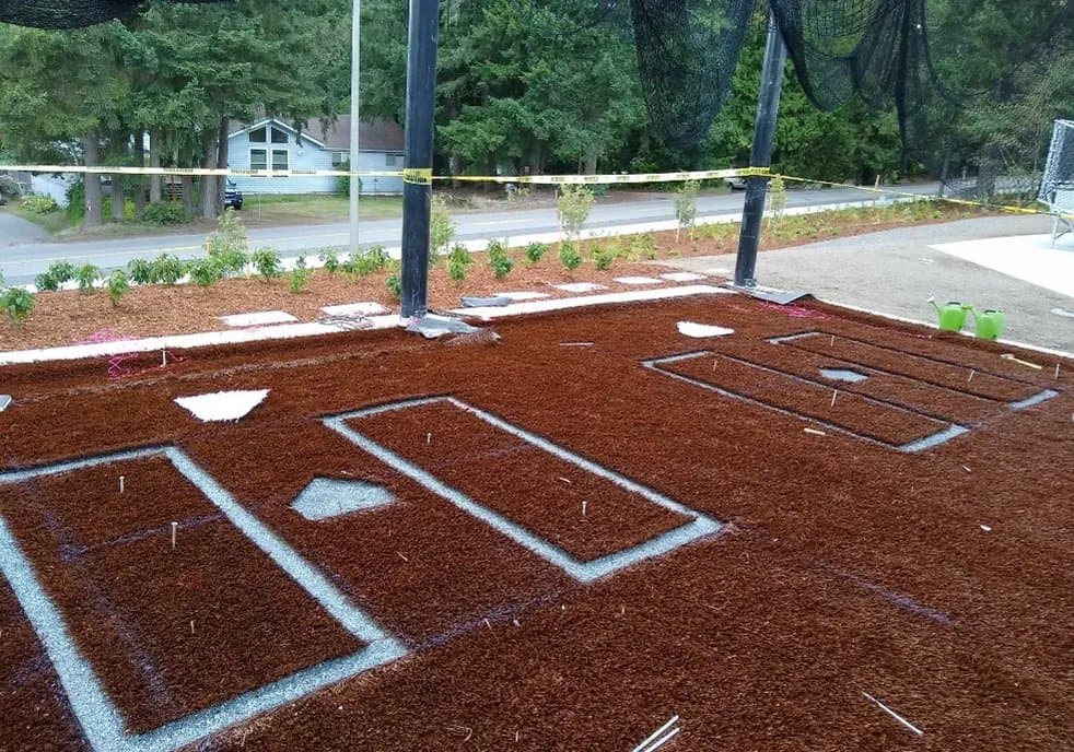 Playground turf base preparation with layout markings before the finished safety surface is installed