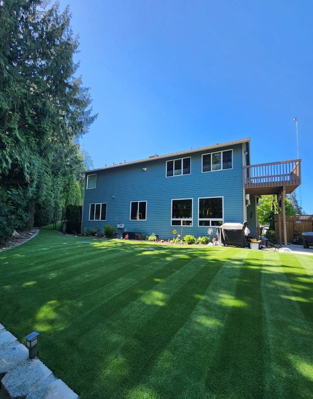 Backyard artificial lawn with a mowed-stripe finish that stays green all year